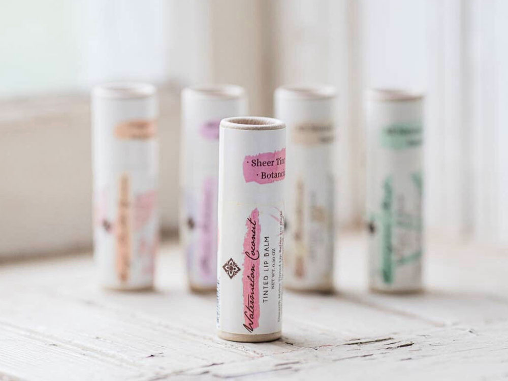 Watermelon Coconut Tinted Organic Lip Balm is made with organic oils and butters and is infused with natural botanical pigments. It provides sheer color and moisturizing benefits.